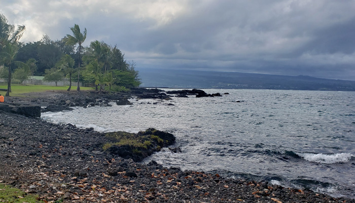 Keaukaha Beach Park in Hilo, Hawaii; a shoreline covered with volcanic rocks 