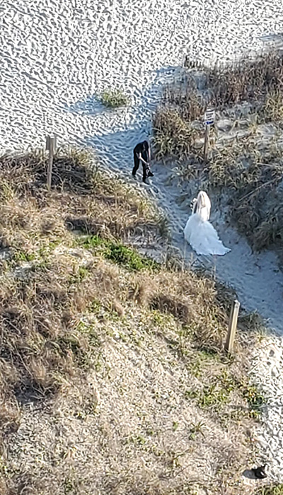 bride walking to beach wedding