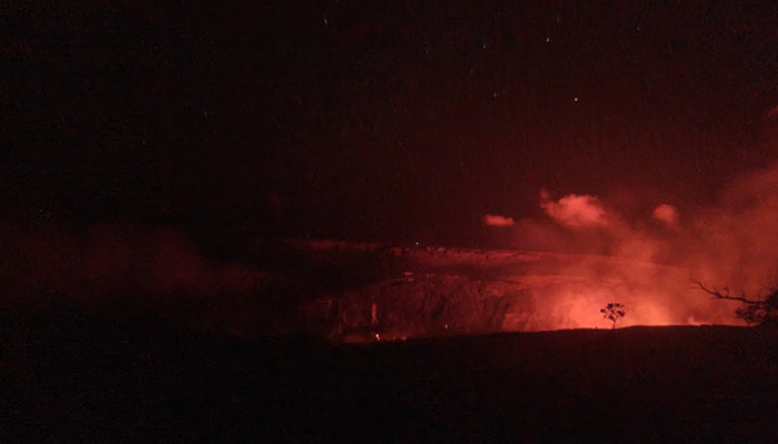 glow from lava reflected in mists above the volcano